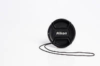Кришка на об'єктив з написом Nikon 77 mm
