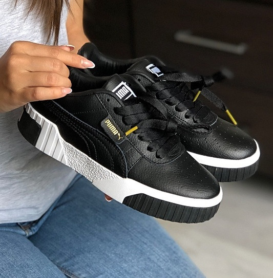 black and white leather pumas