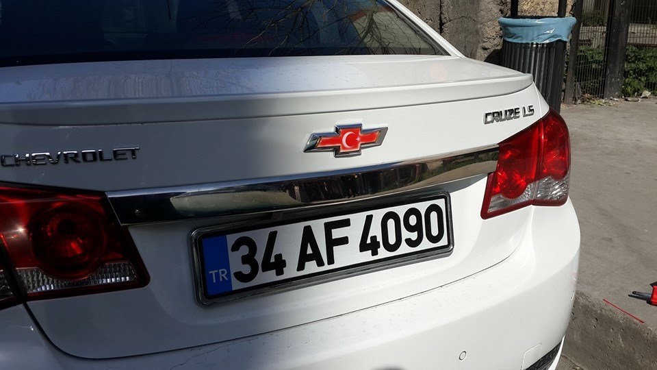 

Chevrolet Cruze 2009↗ гг. Накладка над номером (нерж) Carmos - Турецкая сталь